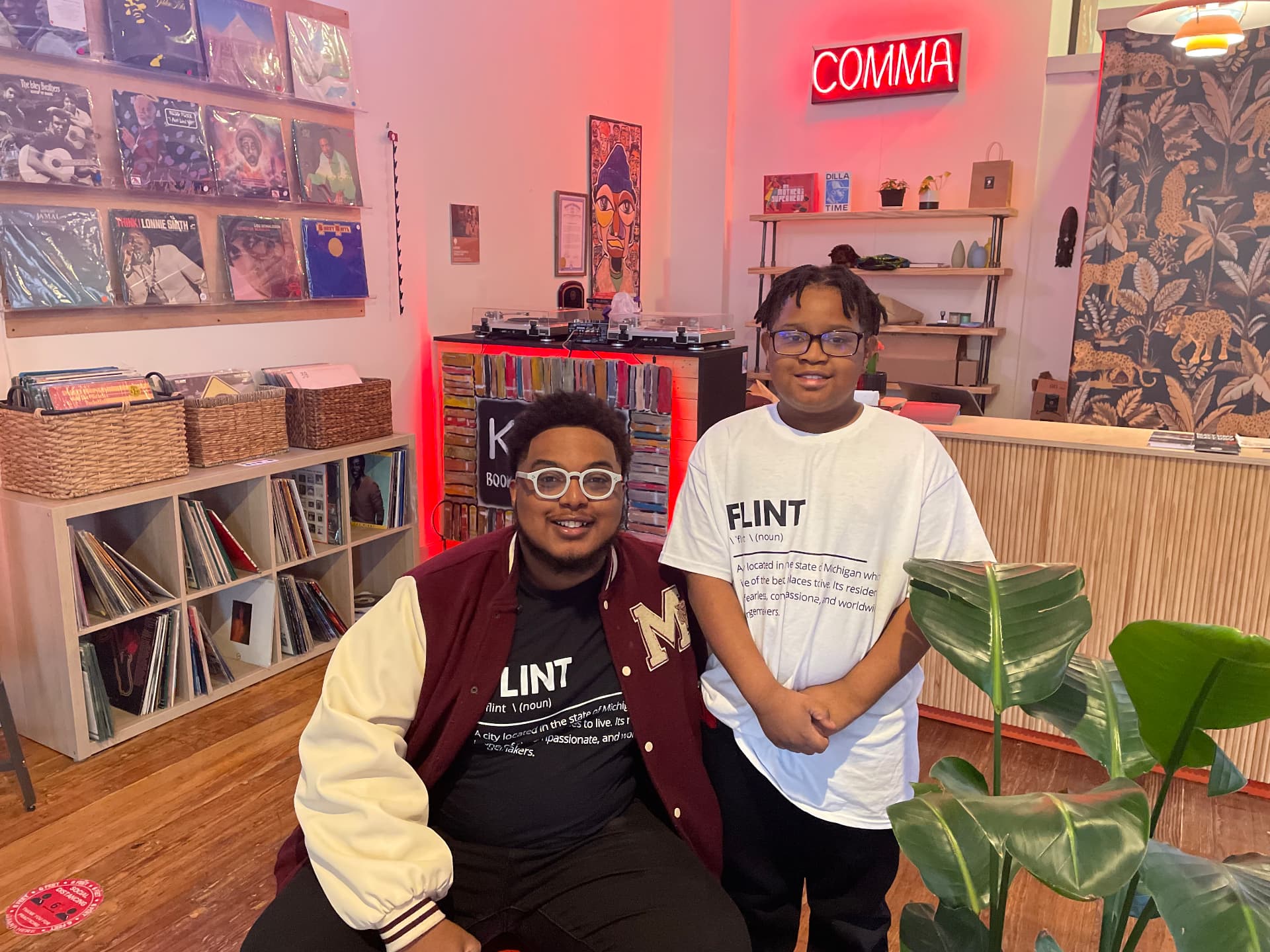 A FliKidz mentor seated beside a young participant in a creative community space